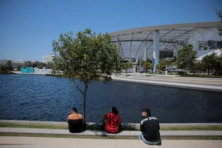 People sit outside SoFi Stadium as Los Angeles prepares for the 2026 World Cup